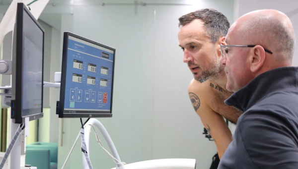 Patrick Blennerhassett and Dr Dejan Jovanovic looking over his VO2 results at Emirates SportsMed. Photo: Emirates SportsMed